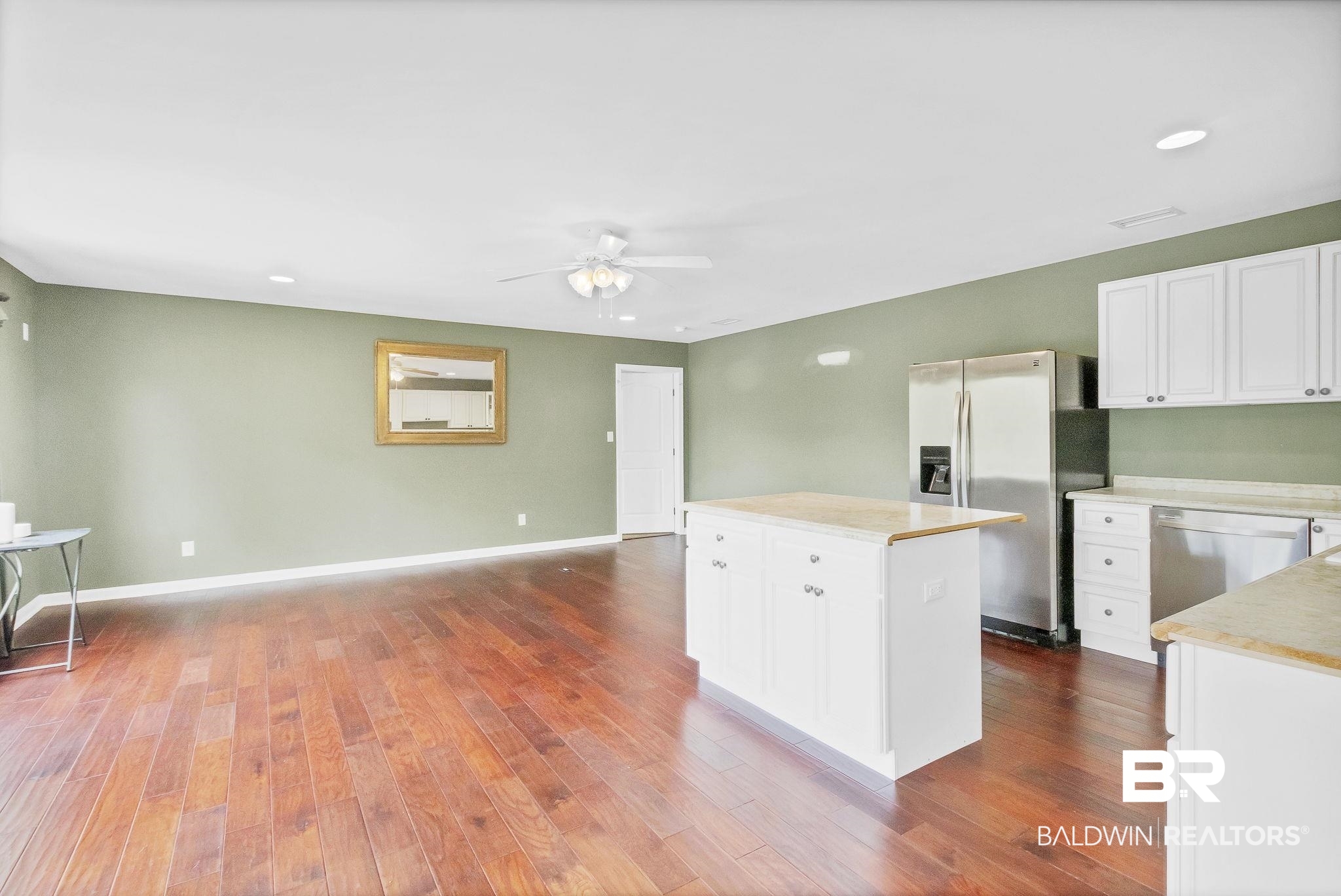 2901 Alston Court Mobile, AL 36605 - Photo 36 of 59 Kitchen featuring a ceiling fan, stainless steel appliances, dark wood-type flooring, a center island, and white cabinets
