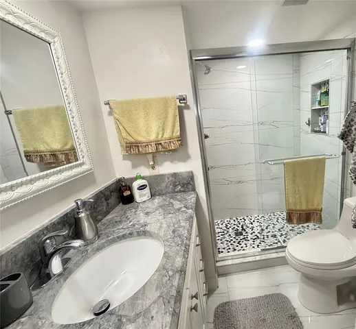 a bathroom with a sink toilet and shower