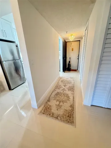 view of a hallway with wooden floor and staircase