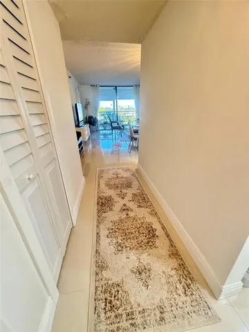 a living room with furniture a flat screen tv and a window