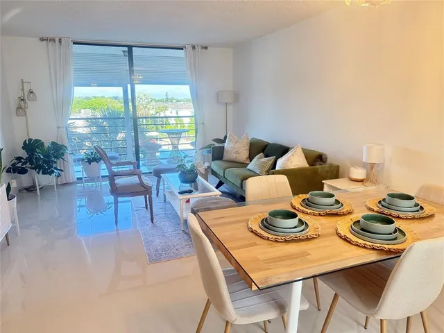 a dinning room with furniture and a window