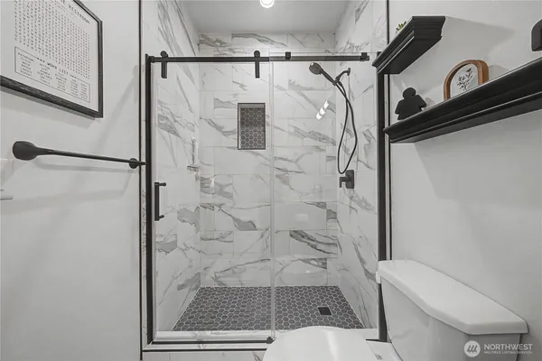 a bathroom with a shower and toilet