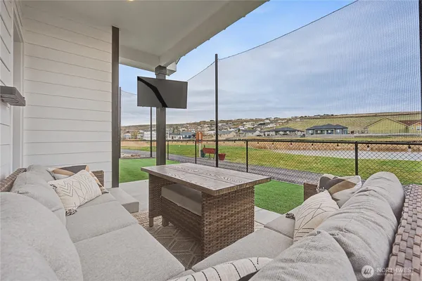a view of a patio with couches and pool