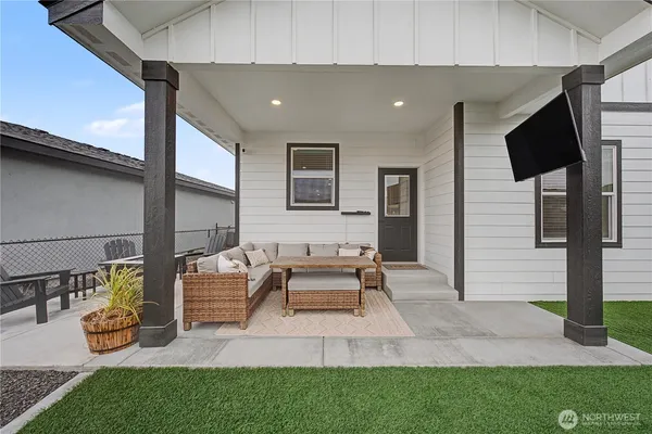 a building outdoor space with patio furniture and garden