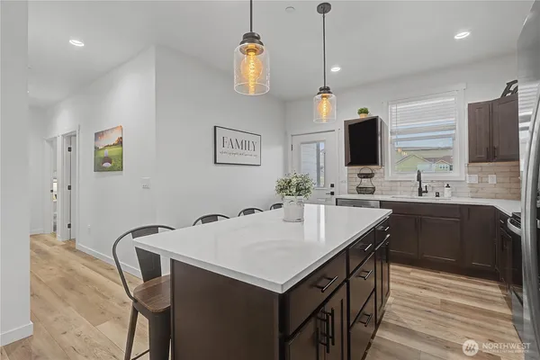 a kitchen with a stove a sink and a refrigerator
