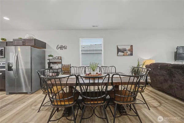 a view of a dining room with furniture and a window