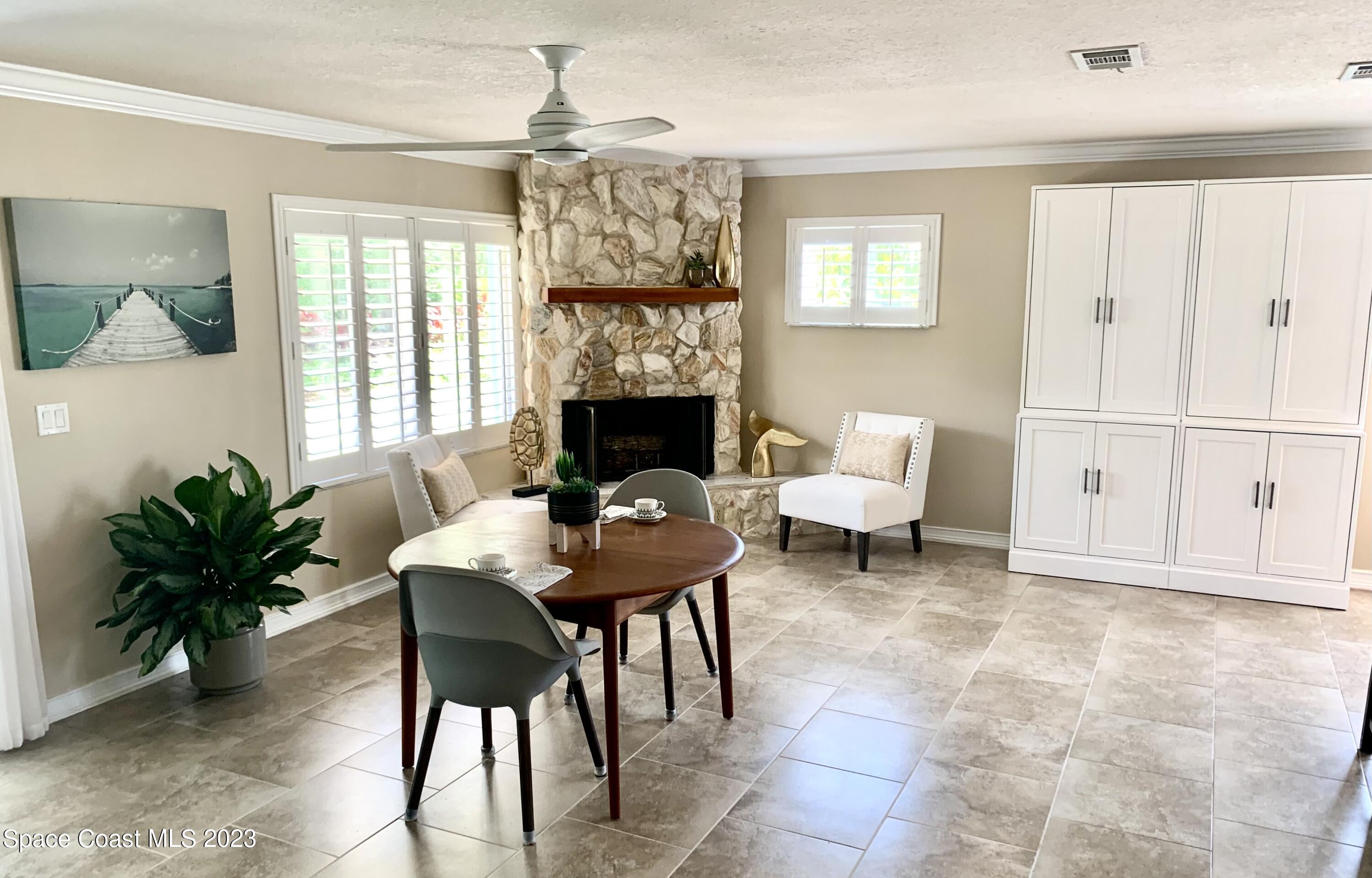 2900 Pine Branch Drive Melbourne, FL 32940 - Photo 14 of 48 a living room with furniture a fireplace and a potted plant
