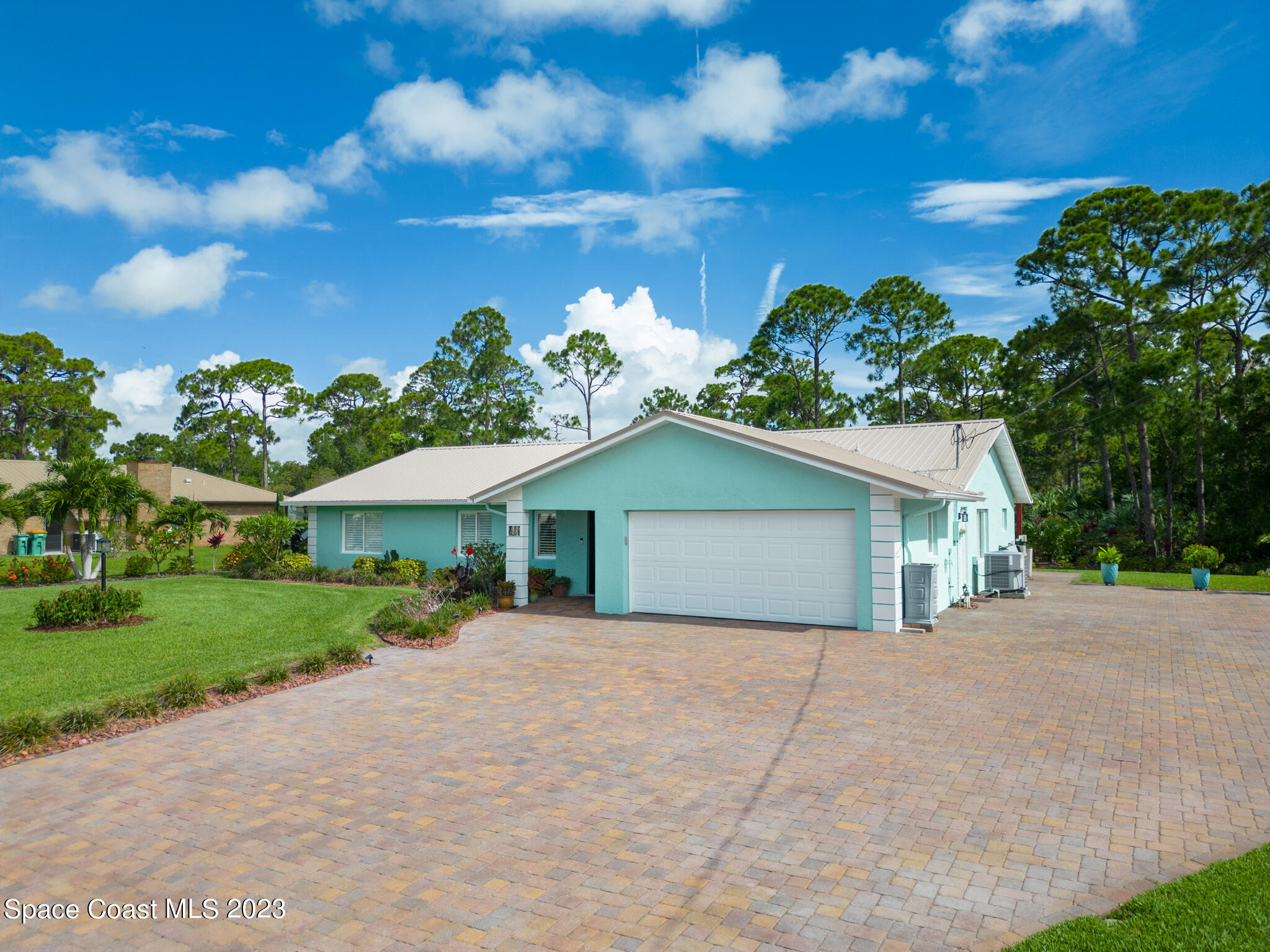 2900 Pine Branch Drive Melbourne, FL 32940 - Photo 45 of 48 a front view of a house with a yard and garage