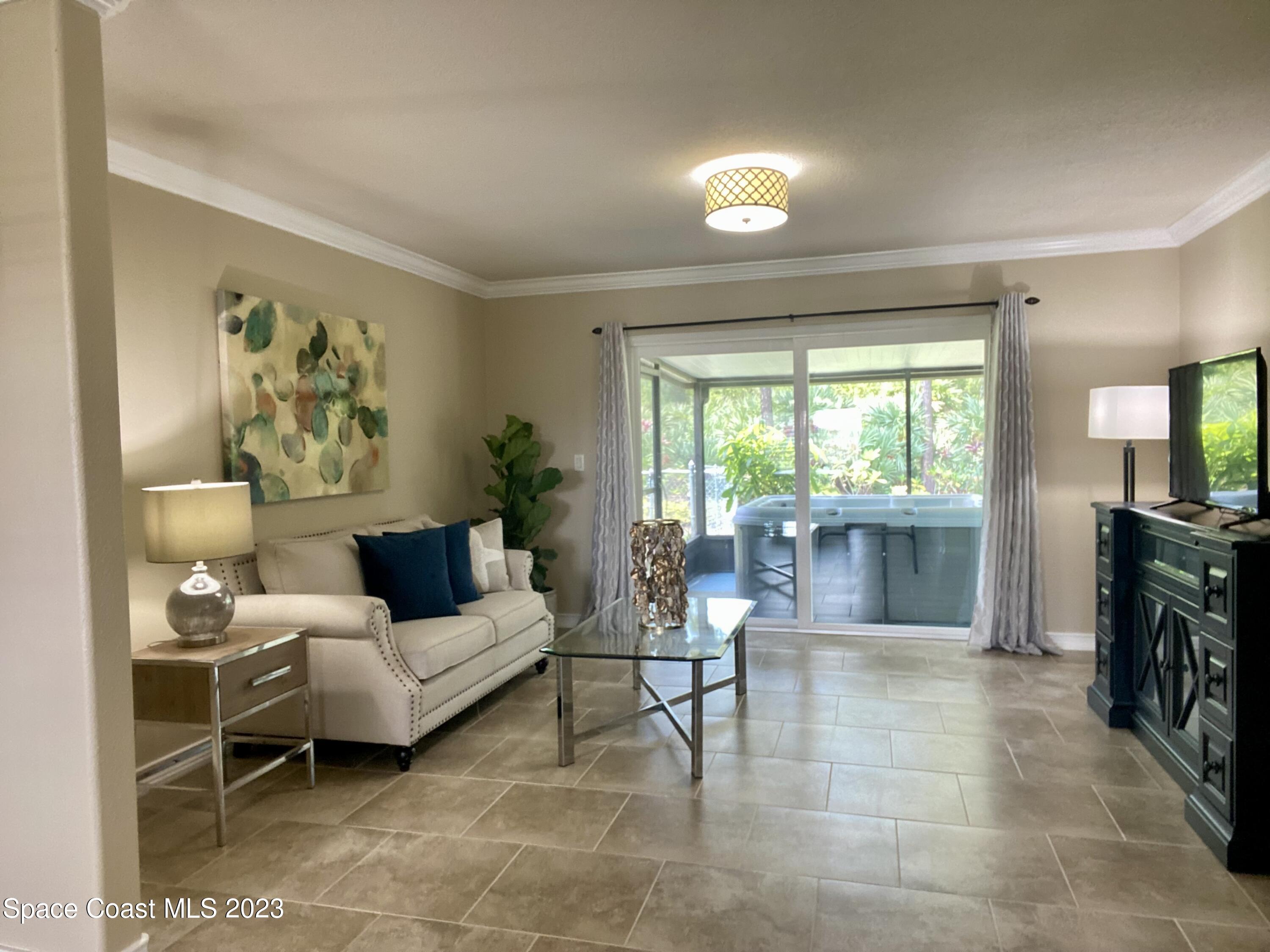 2900 Pine Branch Drive Melbourne, FL 32940 - Photo 9 of 48 a living room with furniture and a large window