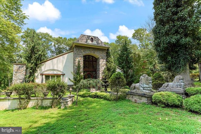 a living room with furniture a fireplace and a large window
