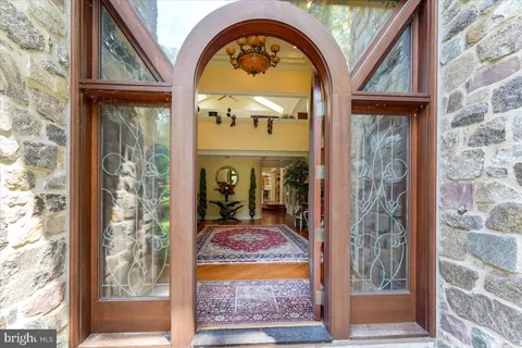 a living room with furniture a rug and a large window