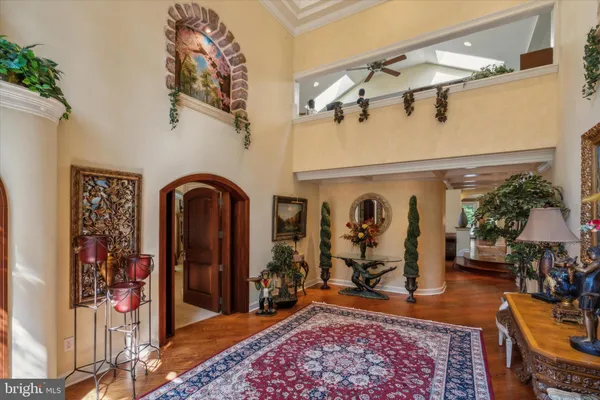 a living room with furniture a rug and a chandelier