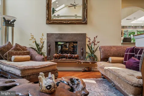 a view of a lake with a yard and large trees