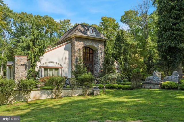 an aerial view of a house with swimming pool and sitting area