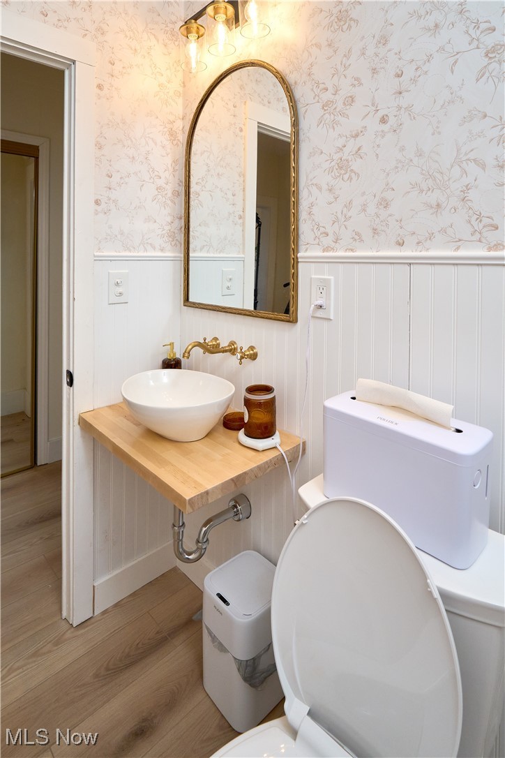 5432 State Road Parma, OH 44134 - Photo 10 of 47 Half bathroom featuring light wood finished floors, vanity, and wallpapered walls