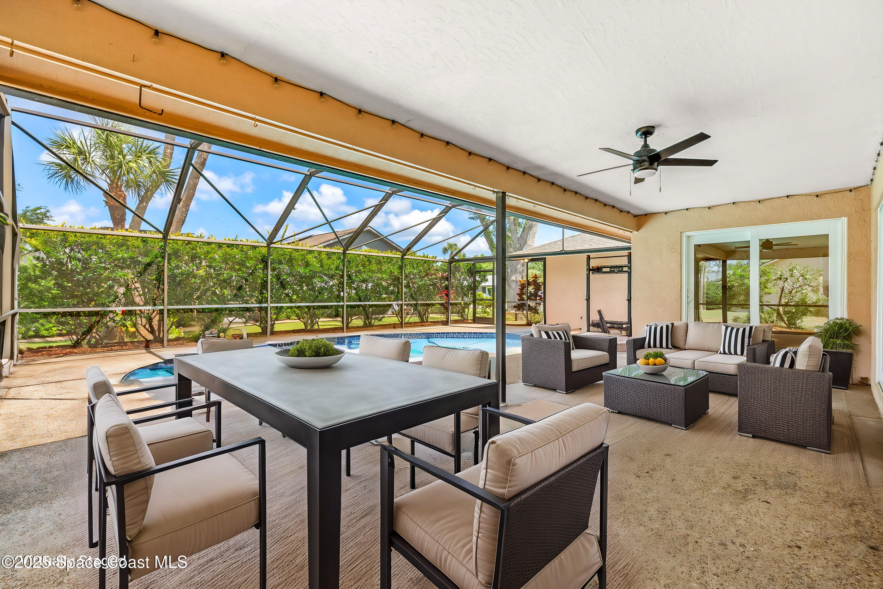 3700 Red Duck Place Melbourne, FL 32934 - Photo 2 of 47 a view of a dining room with furniture large windows and wooden floor