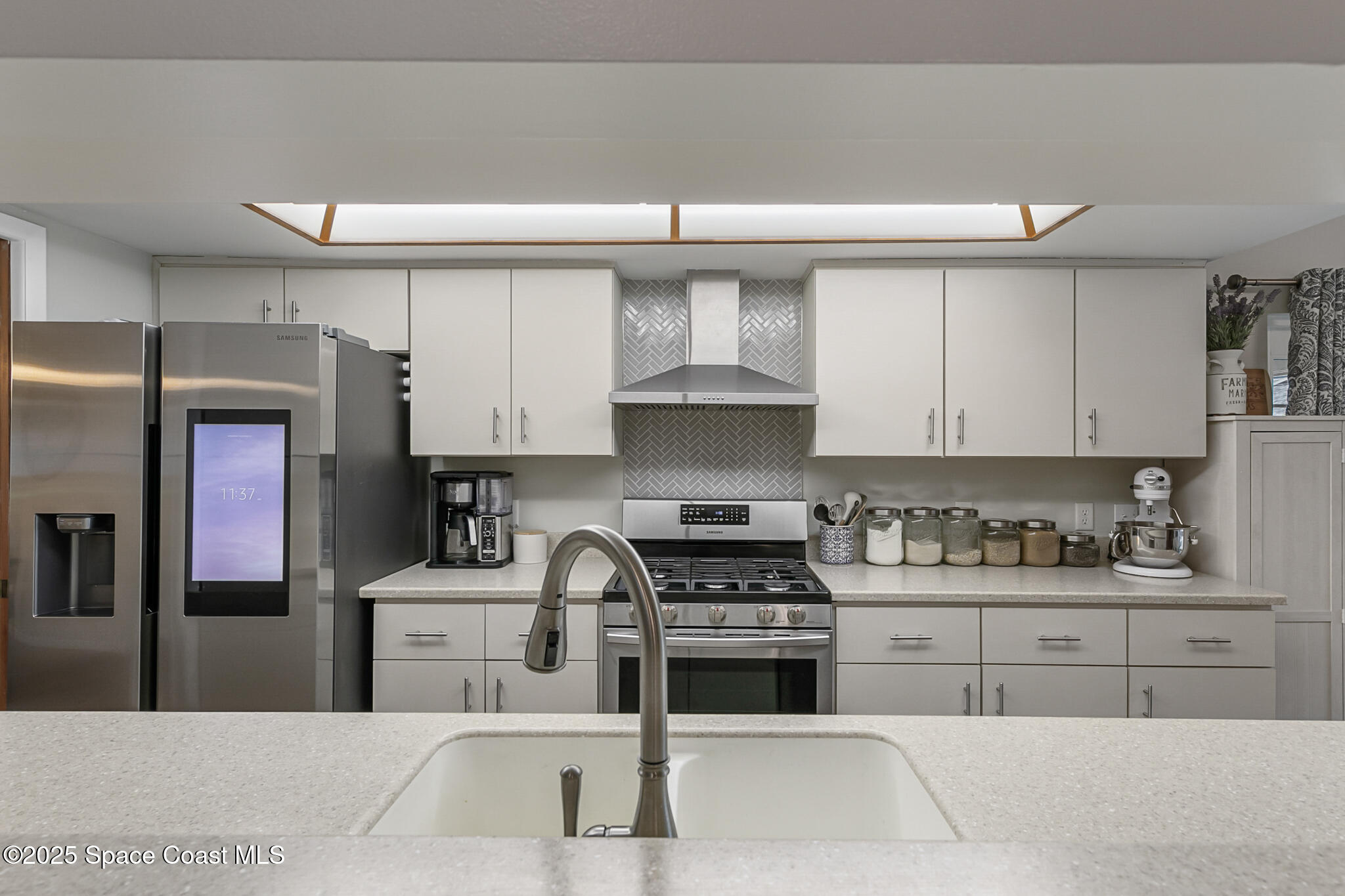 3700 Red Duck Place Melbourne, FL 32934 - Photo 22 of 47 a kitchen with stainless steel appliances granite countertop a sink stove and refrigerator