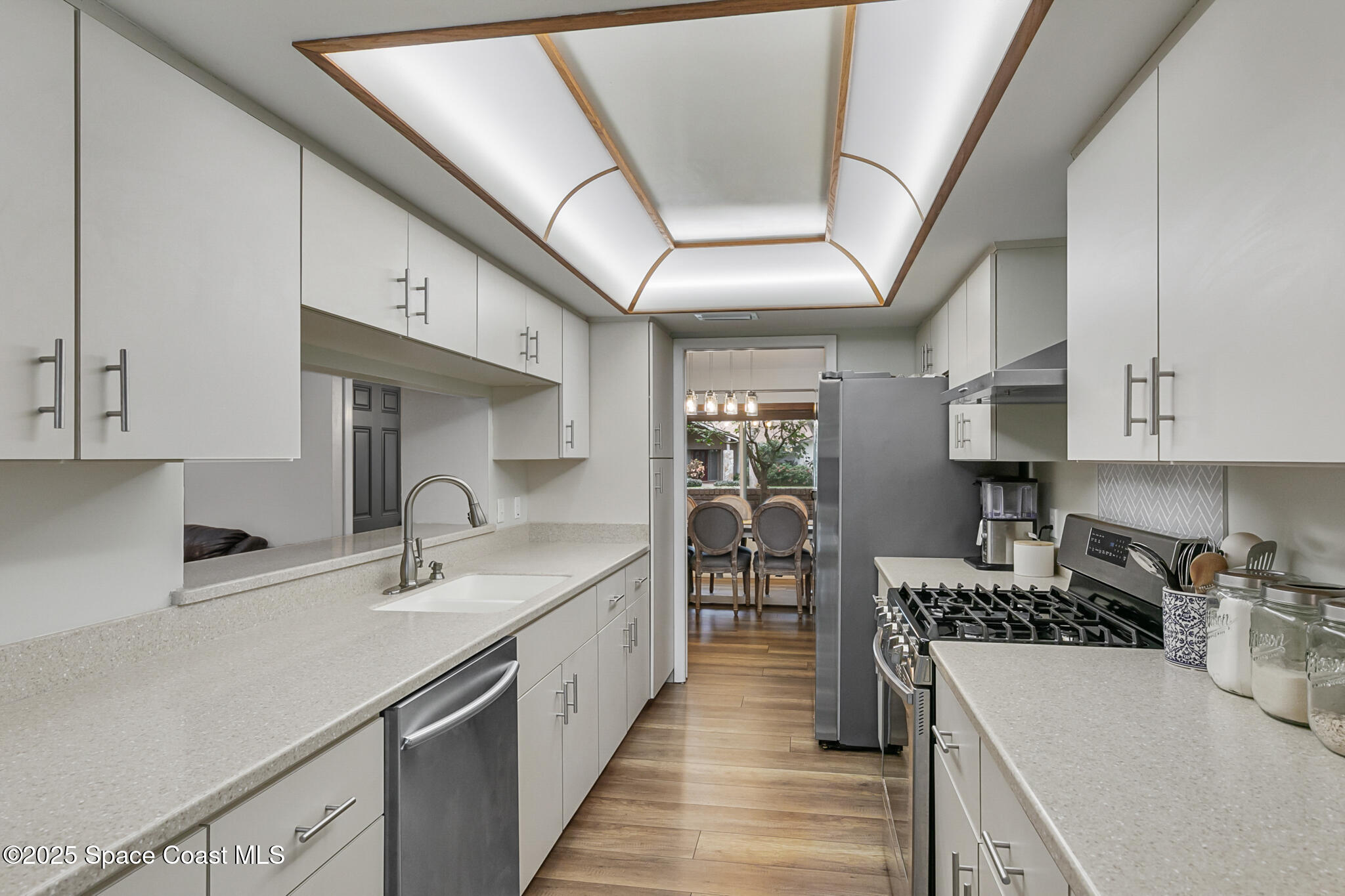 3700 Red Duck Place Melbourne, FL 32934 - Photo 23 of 47 a kitchen with stainless steel appliances granite countertop a sink a stove and a refrigerator