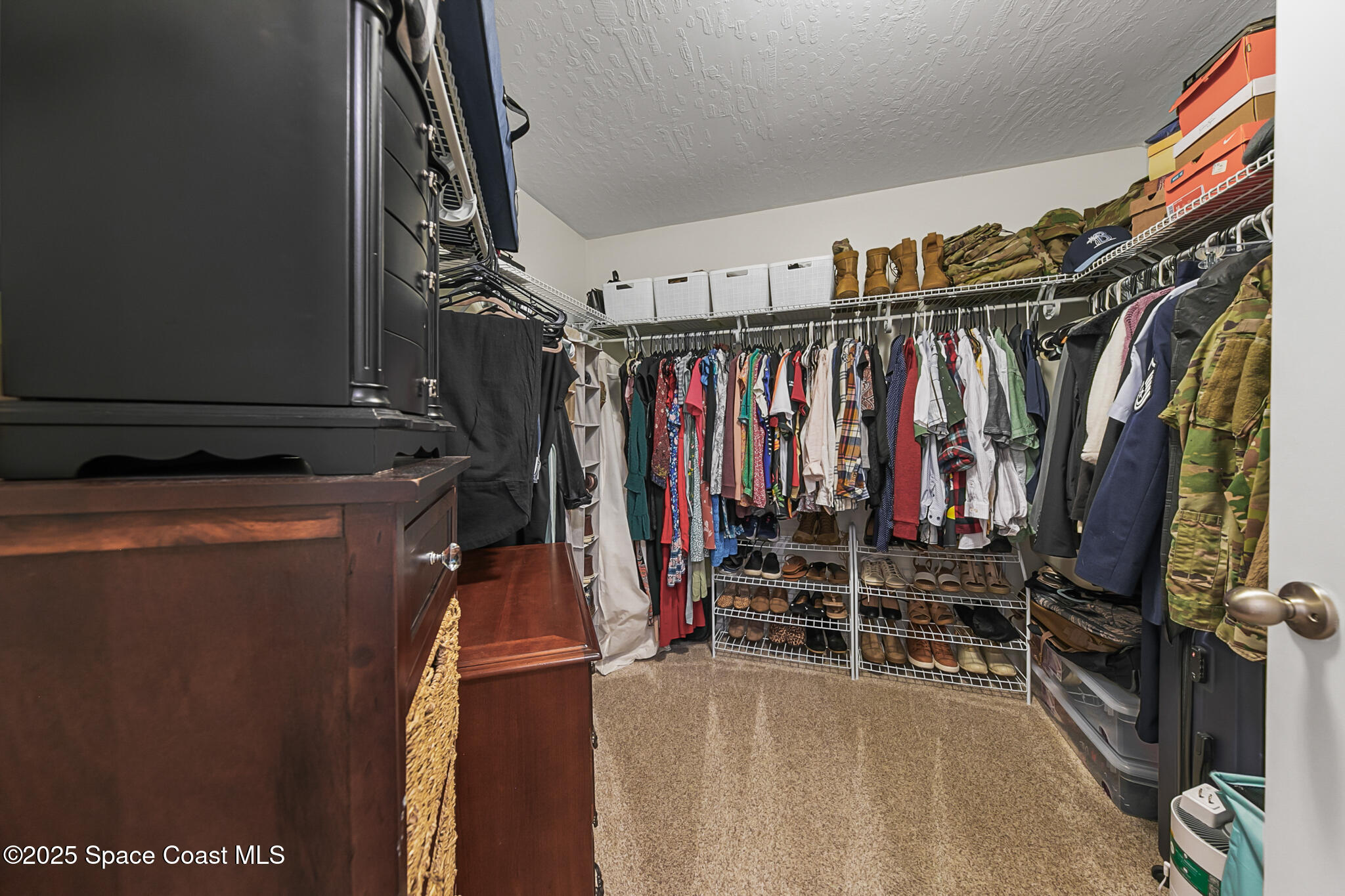 3700 Red Duck Place Melbourne, FL 32934 - Photo 39 of 47 a view of walk in closet with clothes and shoes