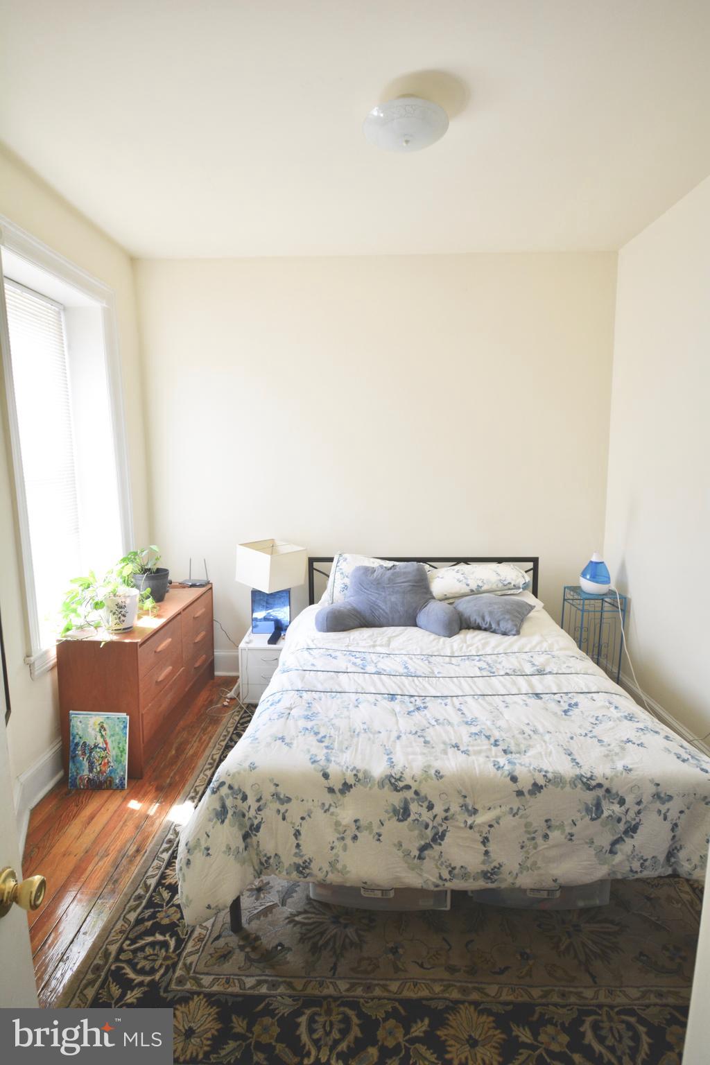 253 Hansberry Street, Unit 1F Philadelphia, PA 19144 - Photo 11 of 20 a bedroom with a bed and a couch