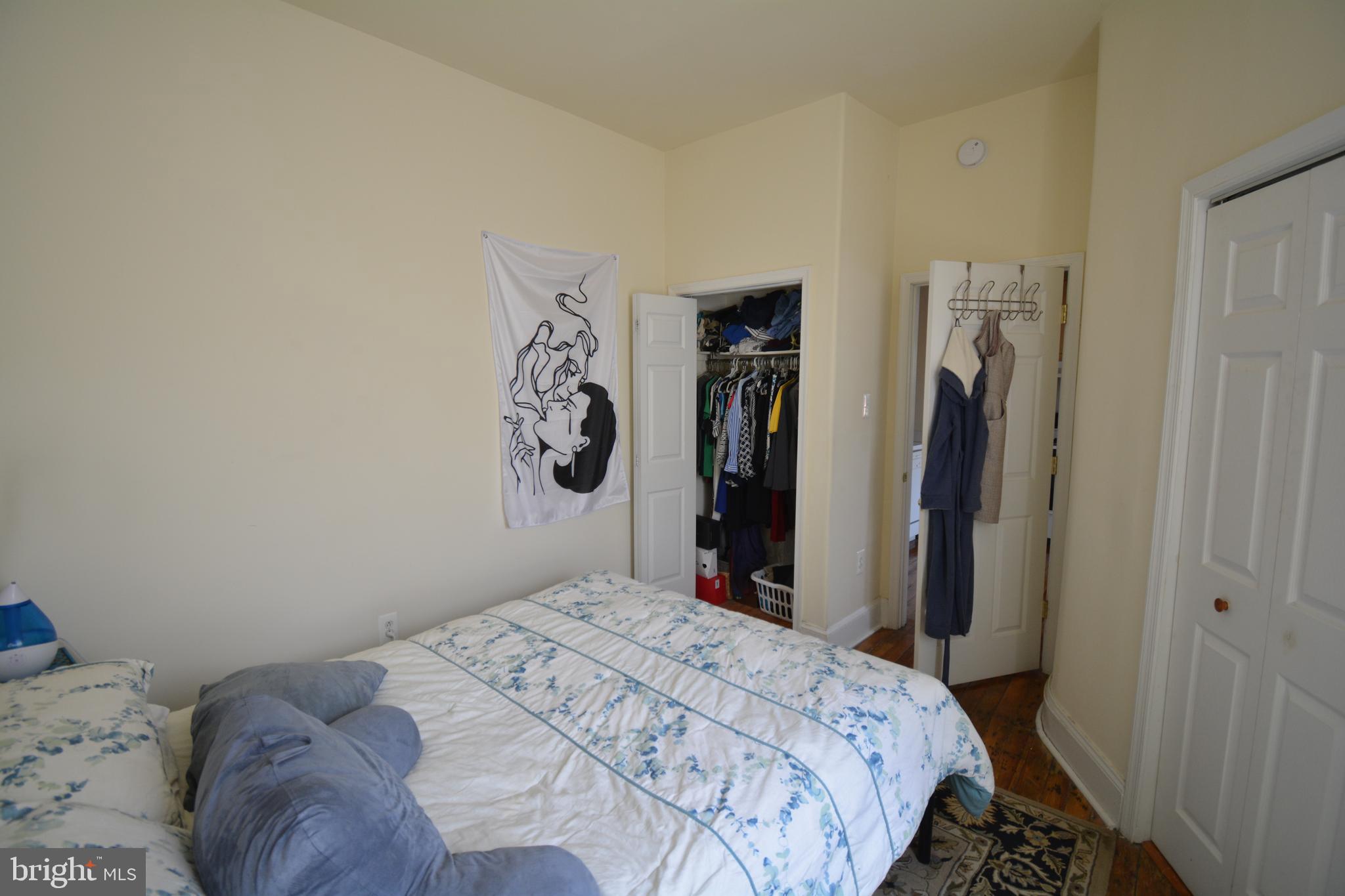 253 Hansberry Street, Unit 1F Philadelphia, PA 19144 - Photo 12 of 20 a bedroom with a bed and a closet