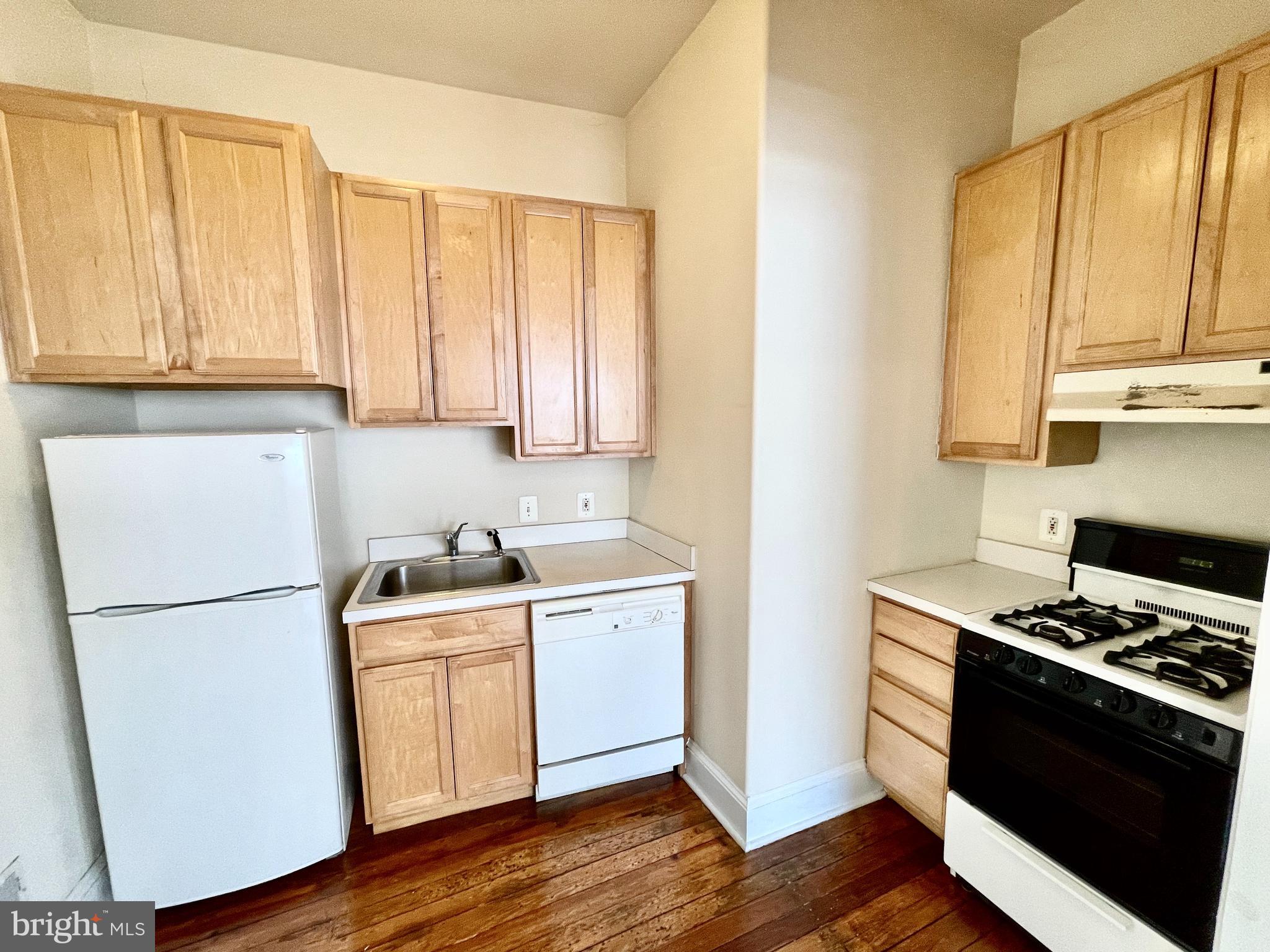 253 Hansberry Street, Unit 1F Philadelphia, PA 19144 - Photo 16 of 20 a kitchen with a stove and a refrigerator