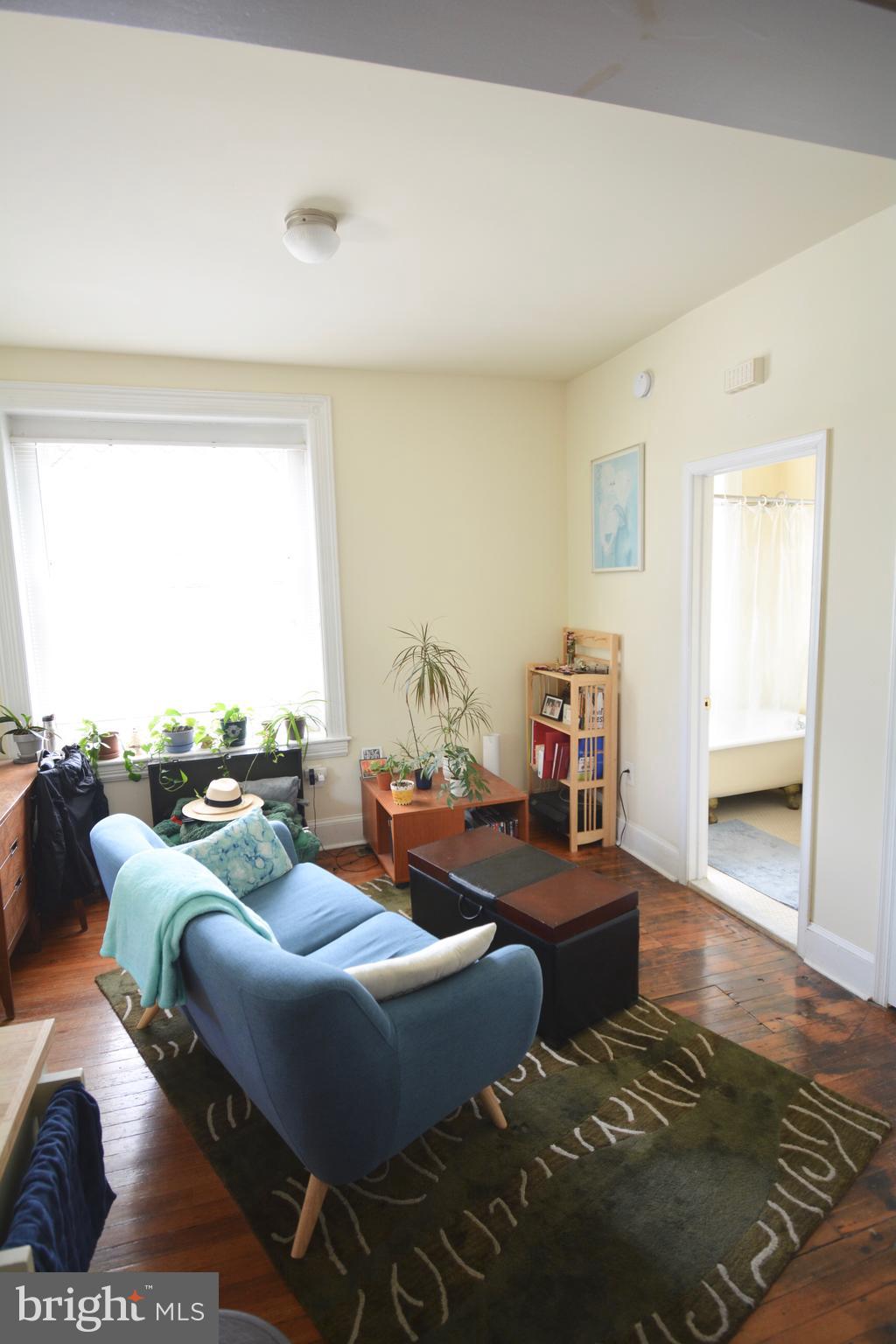 253 Hansberry Street, Unit 1F Philadelphia, PA 19144 - Photo 17 of 20 a living room with furniture and a large window