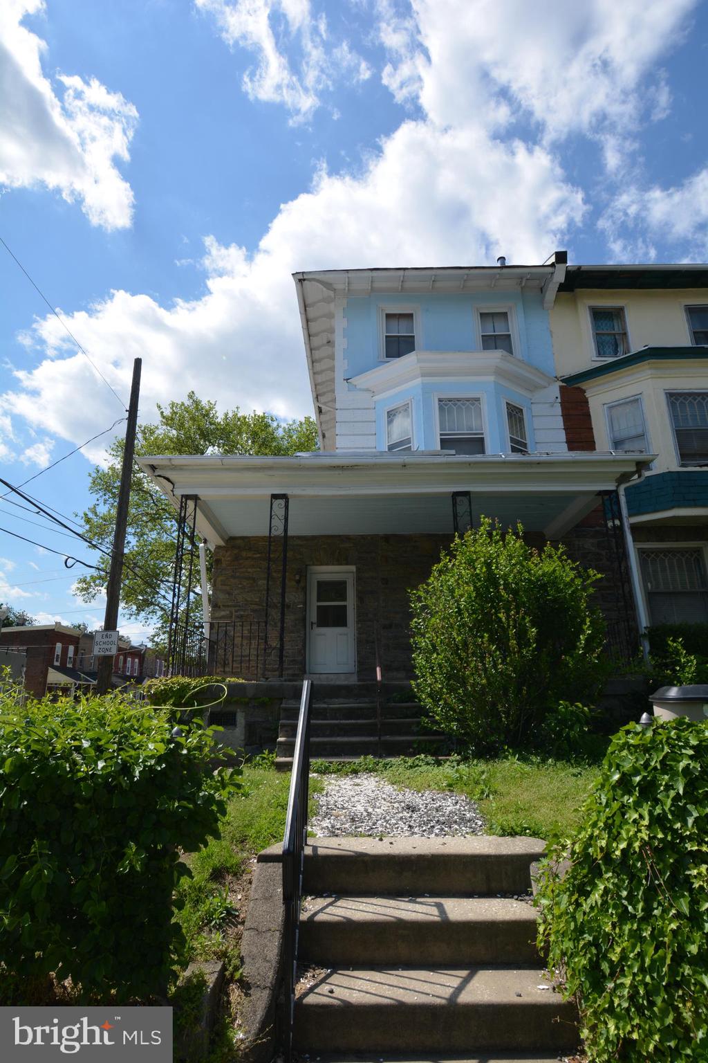 253 Hansberry Street, Unit 1F Philadelphia, PA 19144 - Photo 20 of 20 a front view of a house with a yard