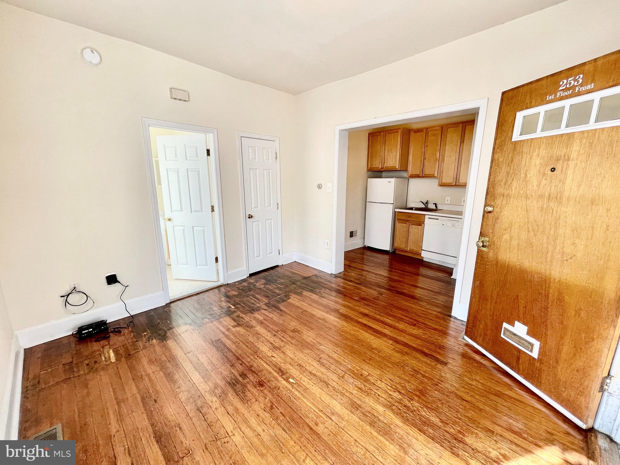 253 Hansberry Street, Unit 1F Philadelphia, PA 19144 - Photo 2 of 20 a spacious bedroom with a bed and a table