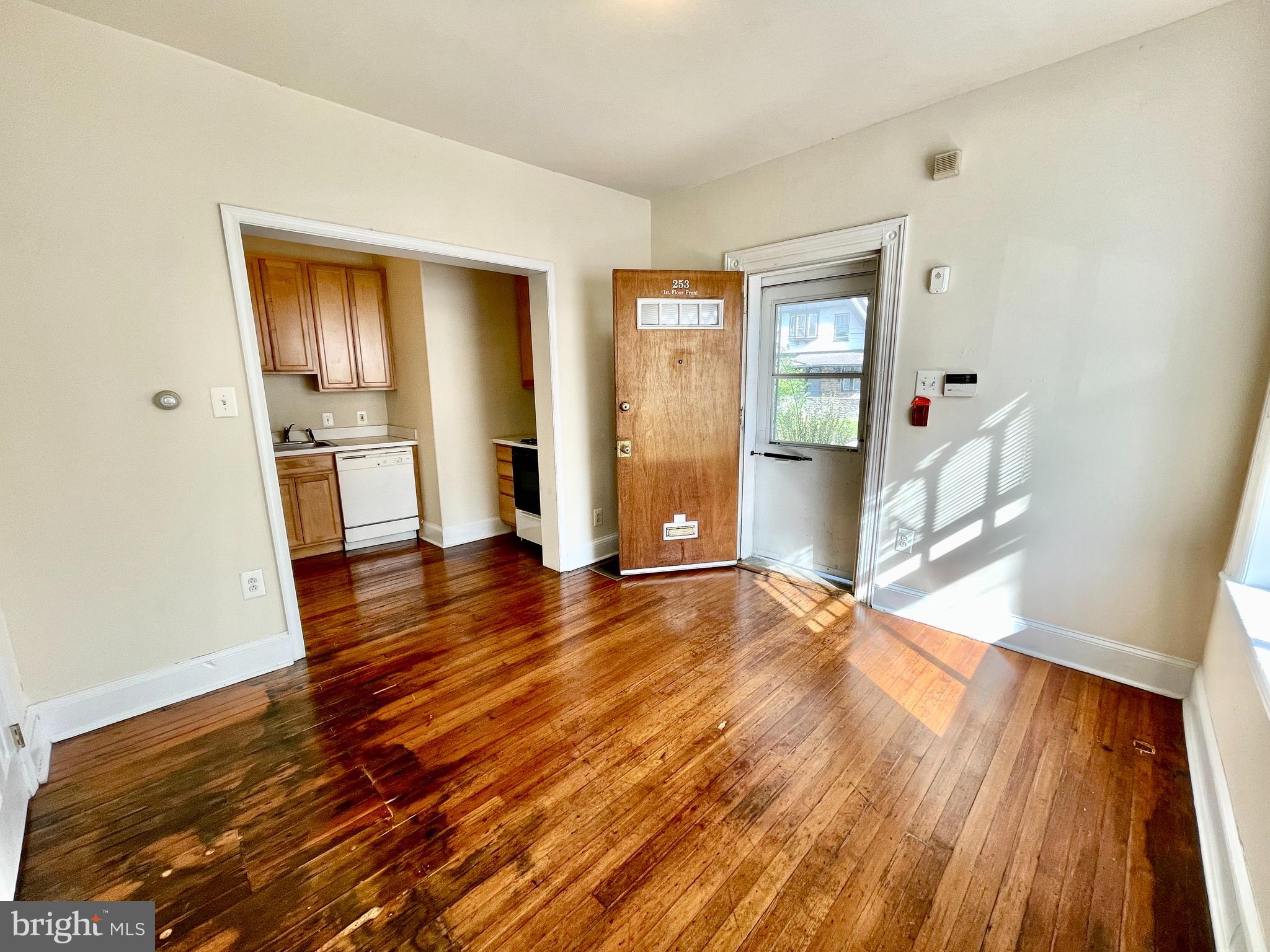 253 Hansberry Street, Unit 1F Philadelphia, PA 19144 - Photo 4 of 20 an empty room with wooden floor and windows