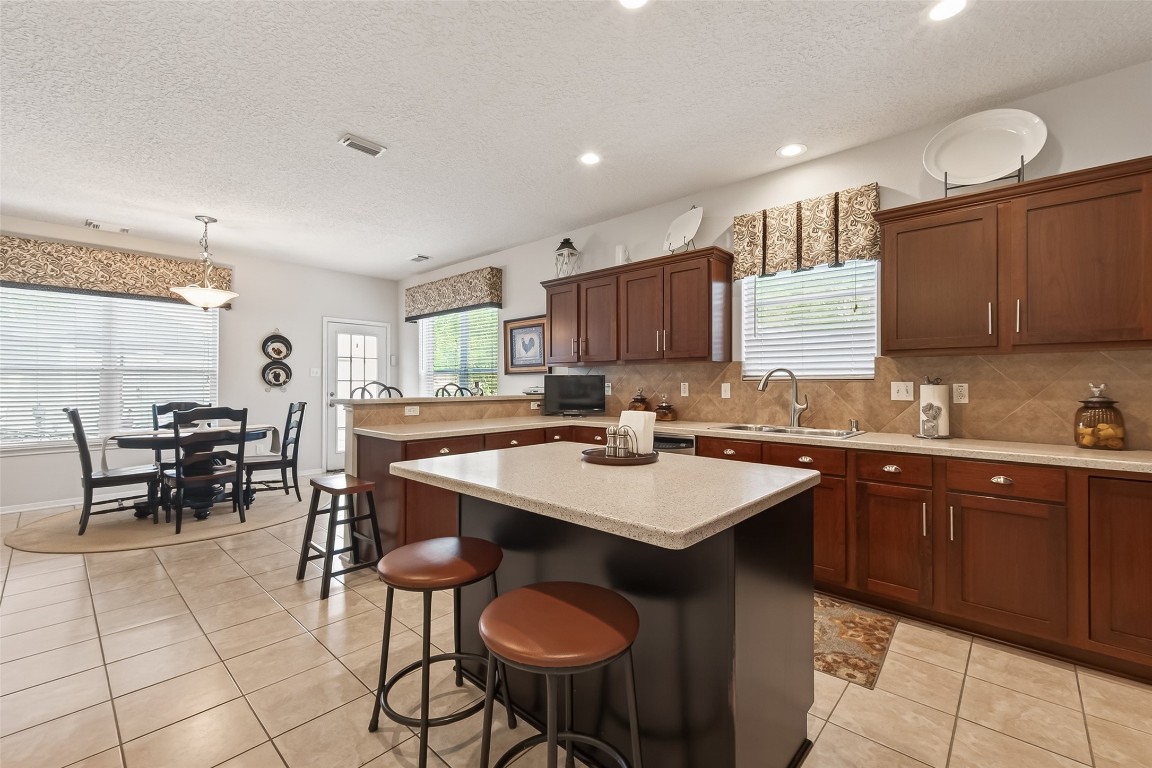 522 Beauregard Drive Conroe, TX 77302 - Photo 16 of 50 a kitchen with a dining table chairs and sink