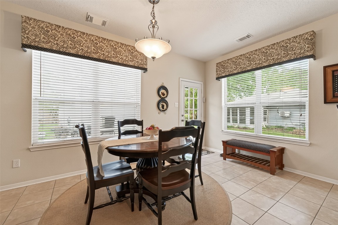 522 Beauregard Drive Conroe, TX 77302 - Photo 22 of 50 a view of a dining room with furniture and chandelier