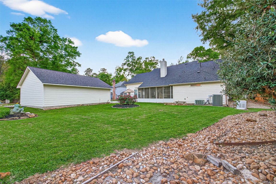522 Beauregard Drive Conroe, TX 77302 - Photo 40 of 50 a front view of a house with garden