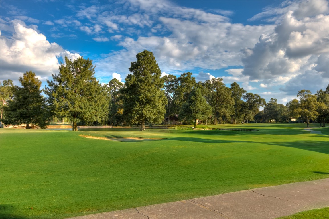 522 Beauregard Drive Conroe, TX 77302 - Photo 48 of 50 a view of a golf course with a lake