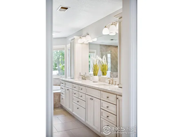 a bathroom with a double vanity sink and mirror