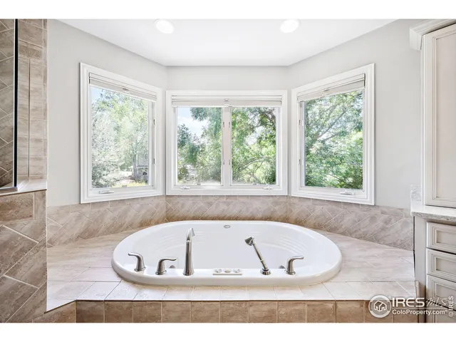 a bath tub sitting in a bathroom next to a window