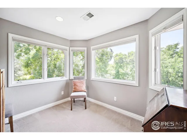 a living room with a window and a dining table
