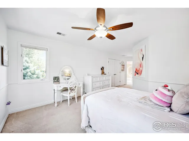 a bedroom with a bed and a chair