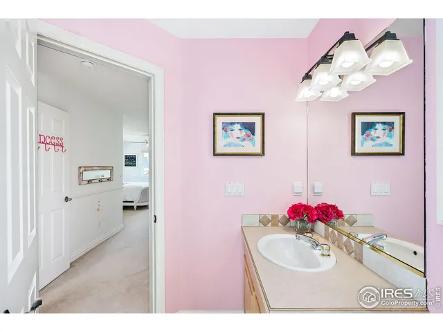 a bathroom with a sink mirror and vanity