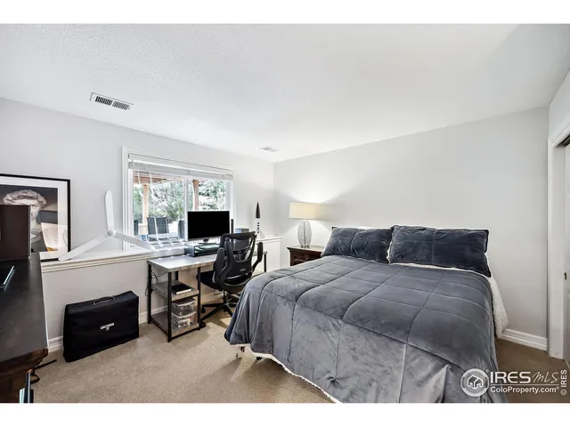 a bedroom with a bed and a television