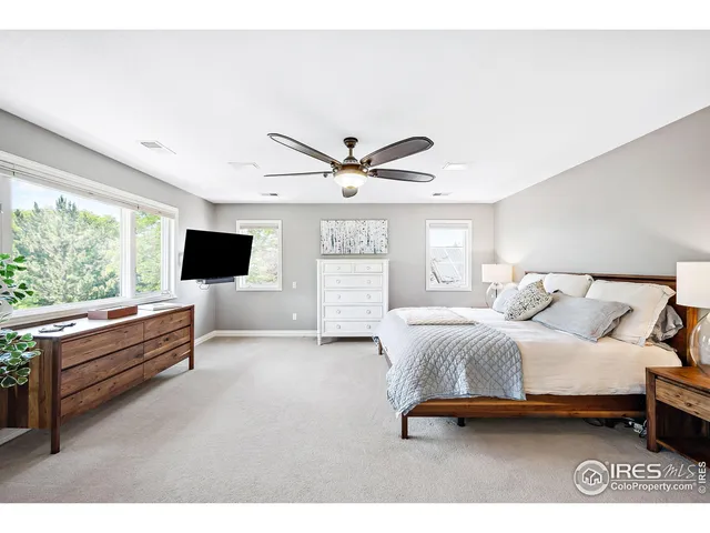 a living room with a bed furniture and a large window