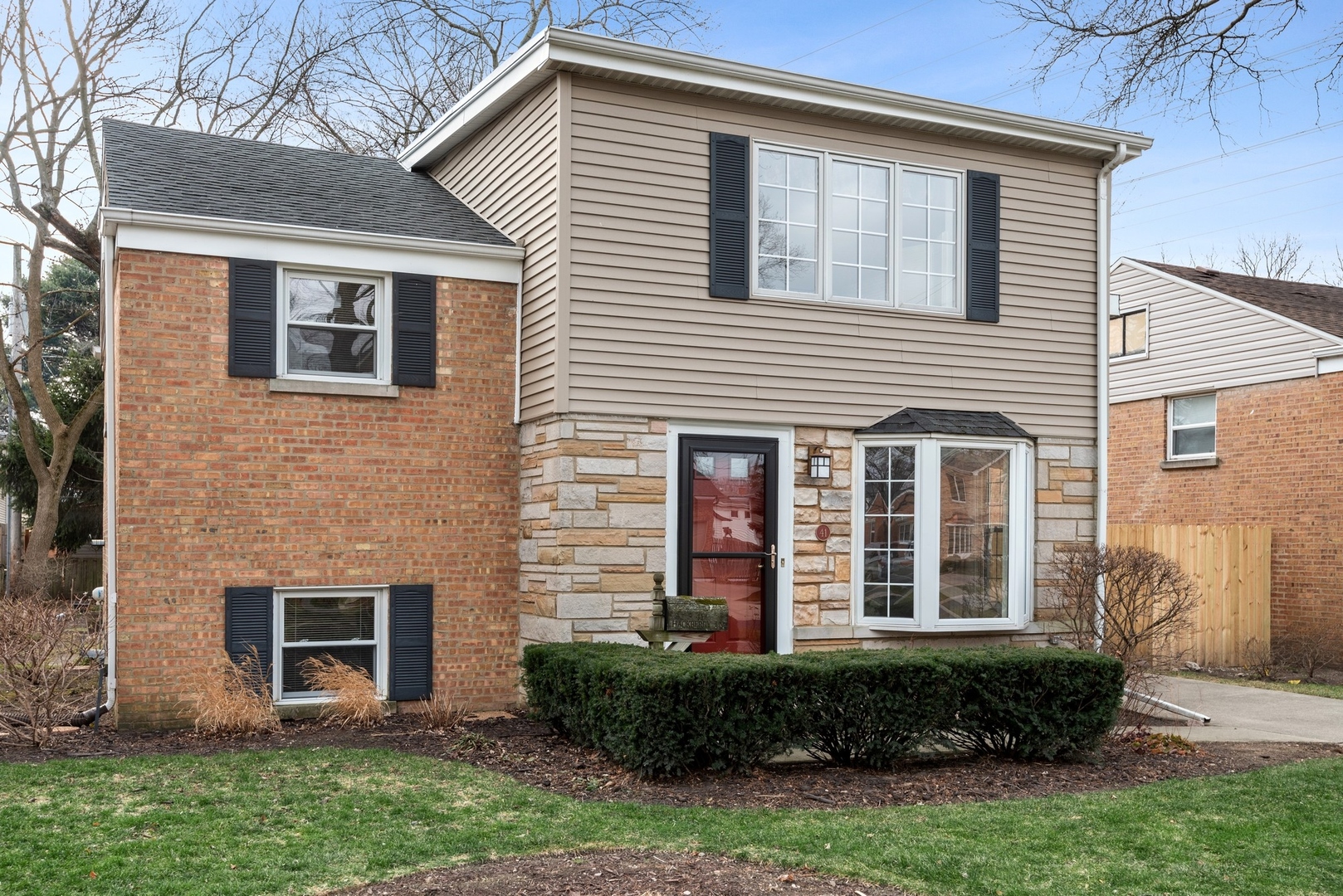 41 Hackberry Lane Glenview, IL 60025 - Photo 2 of 21 a view of a house with brick walls and a yard with plants