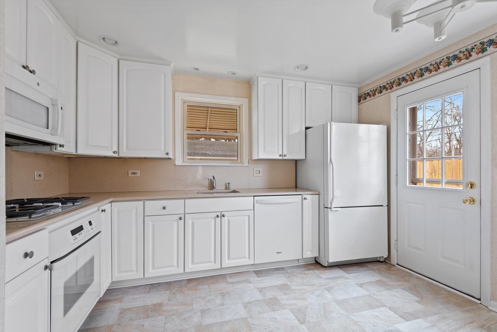 41 Hackberry Lane Glenview, IL 60025 - Photo 7 of 21 a kitchen with white cabinets and refrigerator