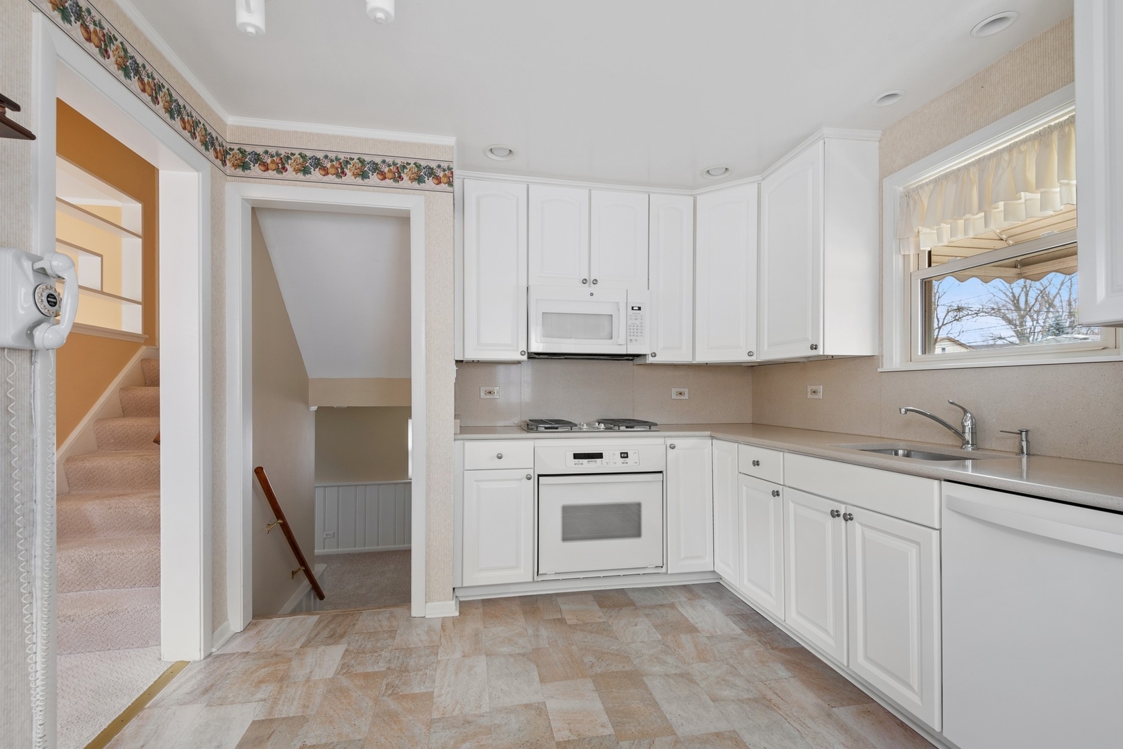 41 Hackberry Lane Glenview, IL 60025 - Photo 9 of 21 a kitchen with white cabinets and white appliances