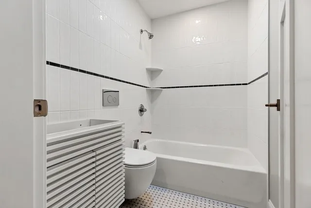 a bathroom with a bathtub and a shower