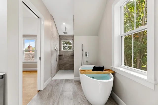 a living room with a couch and a floor to ceiling window