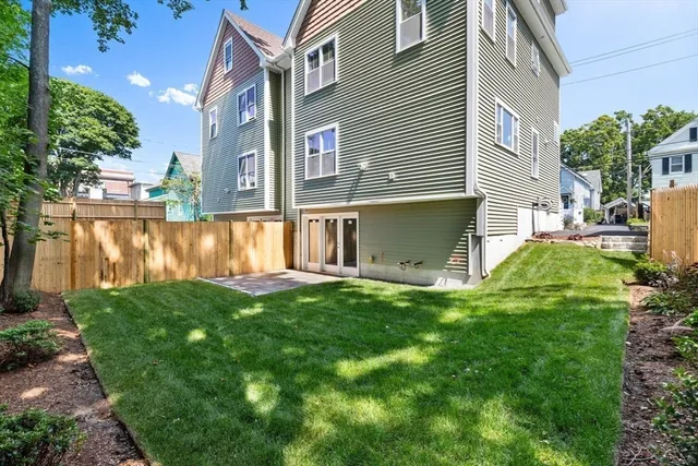 a view of a house with a yard and sitting area