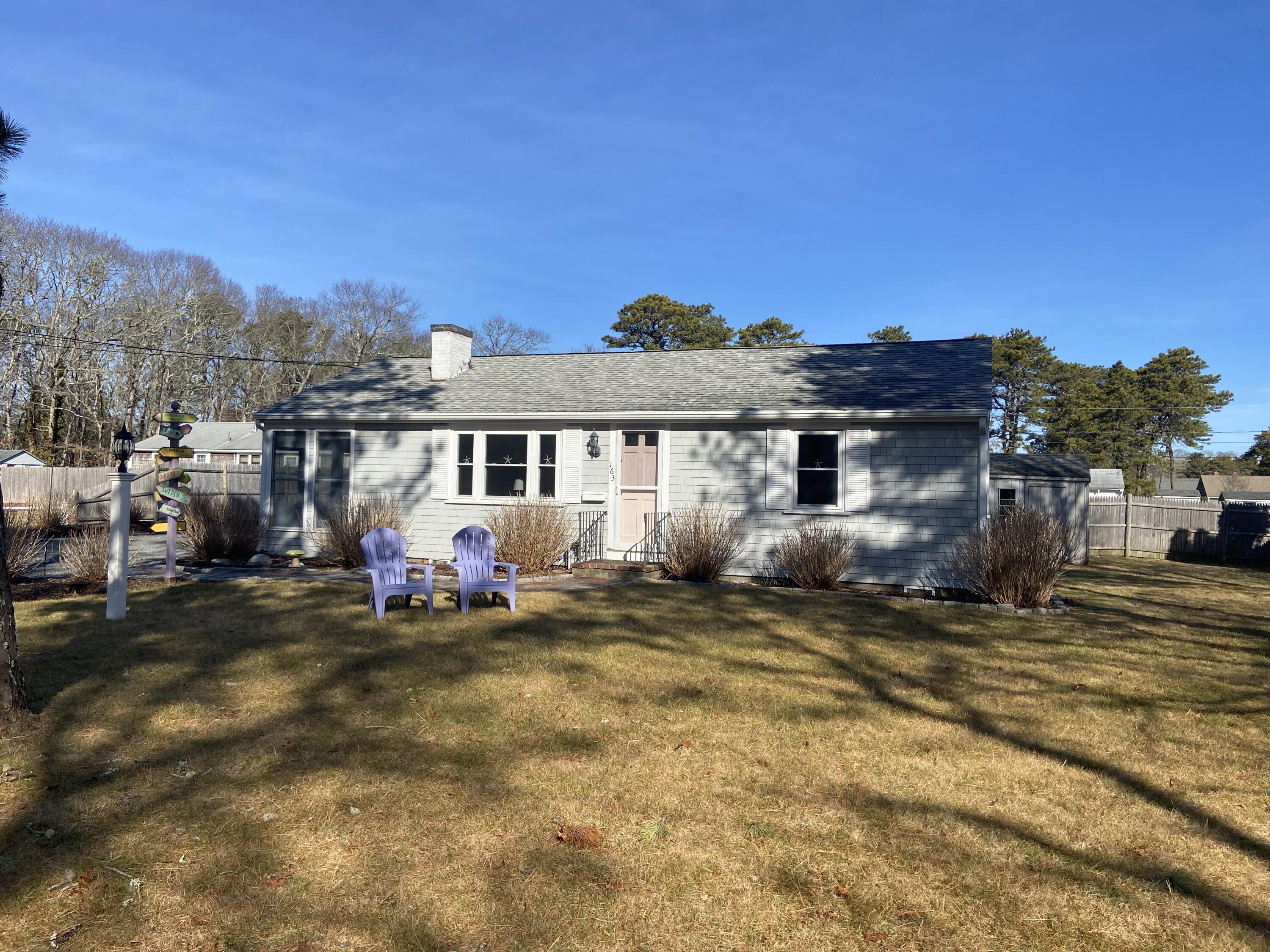 a view of a house with backyard porch and furniture