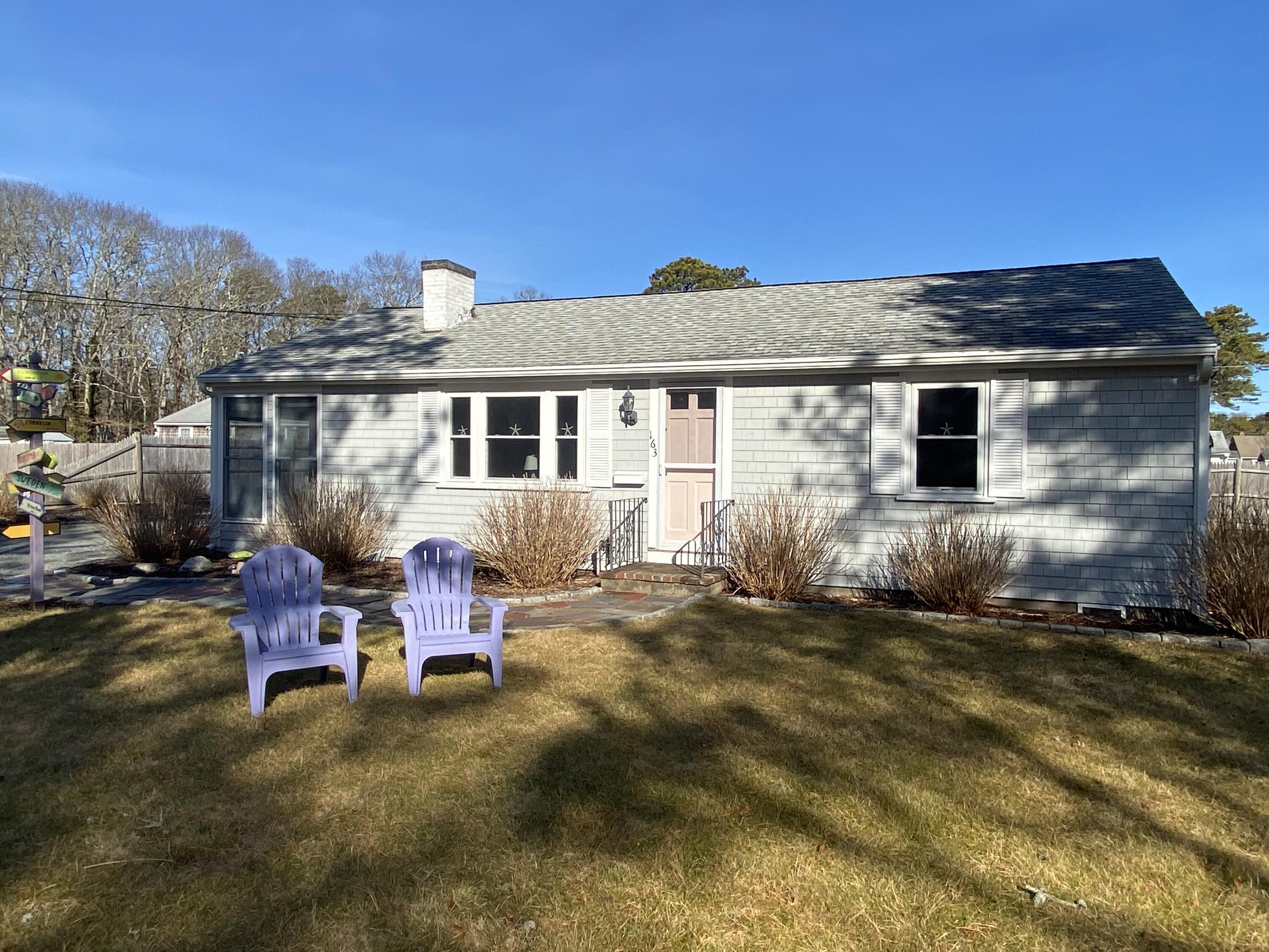 163 Breezy Point Road South Yarmouth, MA 02664 - Photo 2 of 40 a backyard of a house with table and chairs
