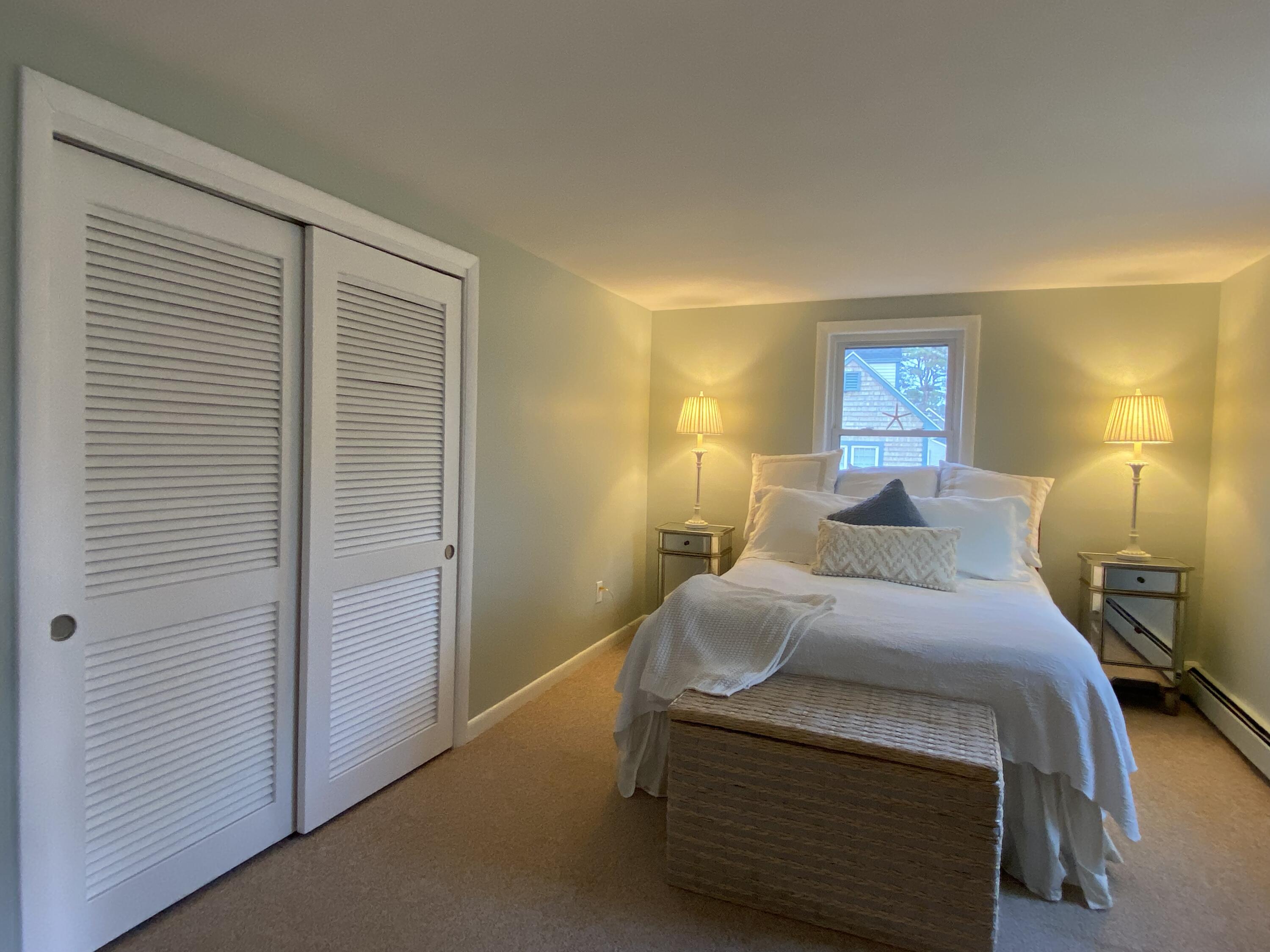 163 Breezy Point Road South Yarmouth, MA 02664 - Photo 23 of 40 a bedroom with a bed and a lamp